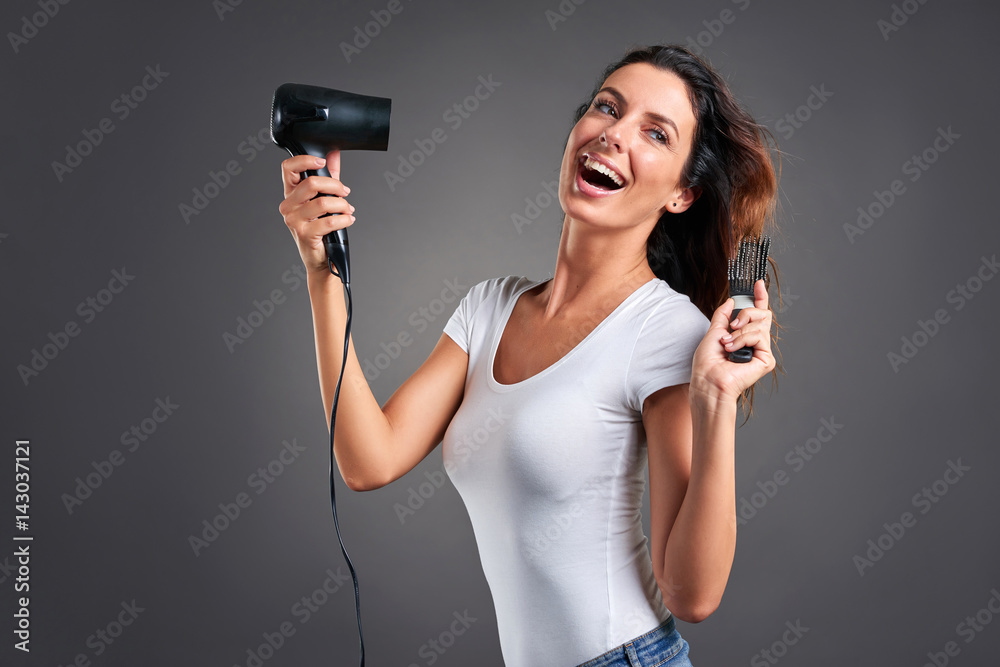 Young woman with hairdryer Young woman with hairdryer