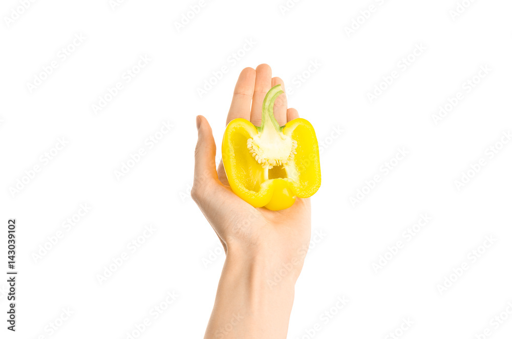 Healthy eating and diet Topic: Human hand holding a half of yellow pepper isolated on a white background in the studio, first-person view Healthy eating and diet Topic: Human hand holding a half of yellow pepper isolated on a white background in the studio, first-person view