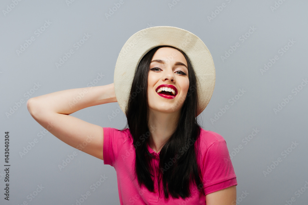 Happy young woman posing over grey background. Happy young woman posing over grey background.