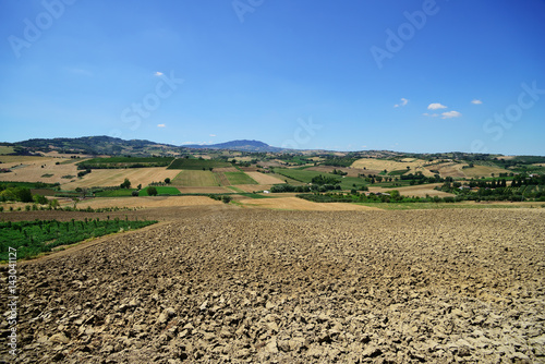 Countryside in Coriano, plowed field (near Rimini), Emilia-Romagna, Italy. Far viev to Monte Titano and San Marino.
