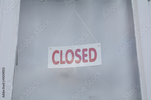Closed sign in shop door window