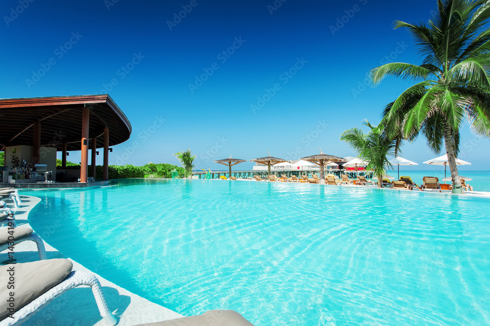 Swimming pool with restaurant at tropical island resort Swimming pool with restaurant at tropical island resort