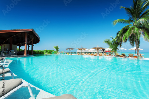 Swimming pool with restaurant at tropical island resort © Ivan Kurmyshov