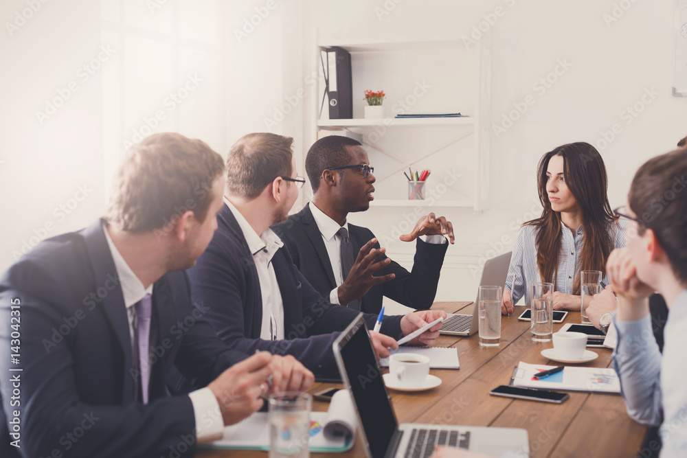Business meeting. Young multiethnic team in modern office Business meeting. Young multiethnic team in modern office