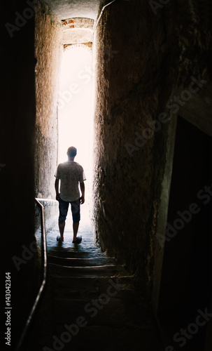 Man silhouette on stairs in narrow street