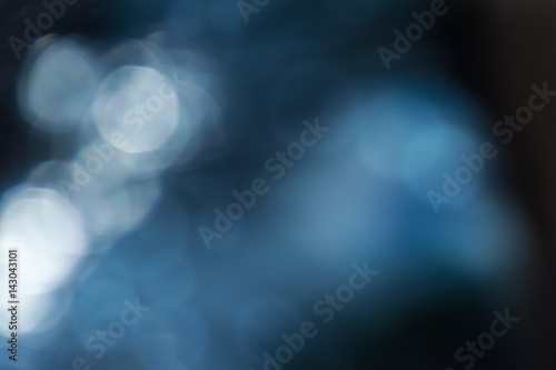 blurred abstract background in dark blue tones with bokeh effect
