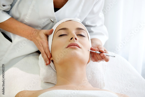 Find Similar  Get a Comp  Save to LightboxSpa salon  young beautiful woman having facial treatment.