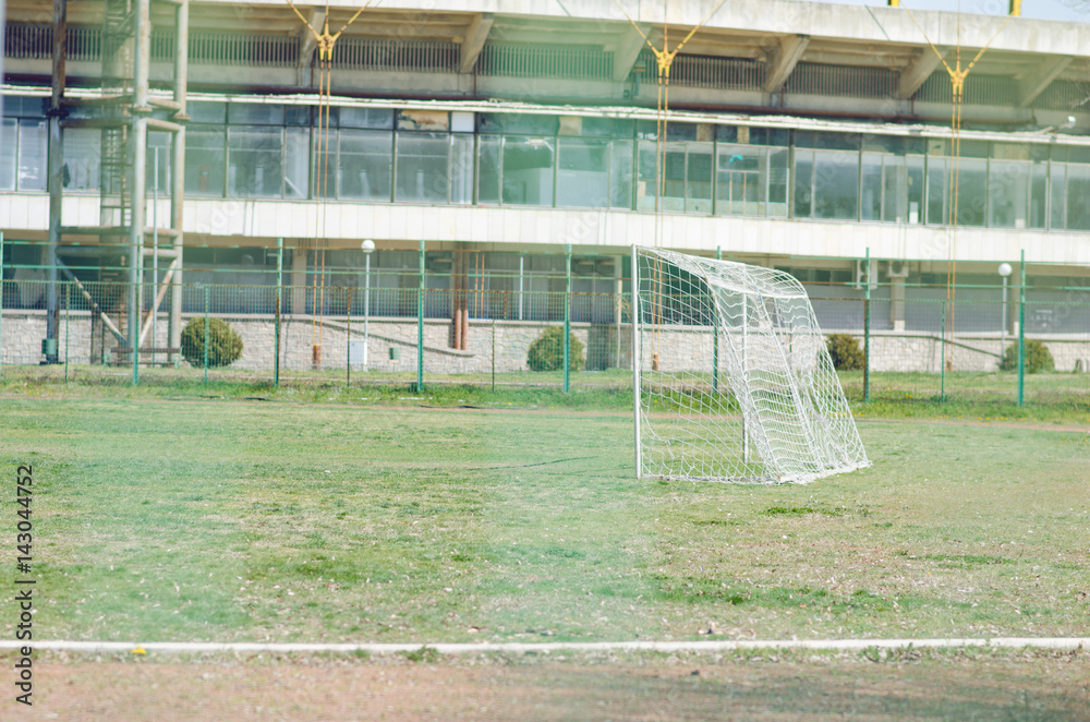 Fototapeta premium Football Field With Green Grass Shot Through Wire Net