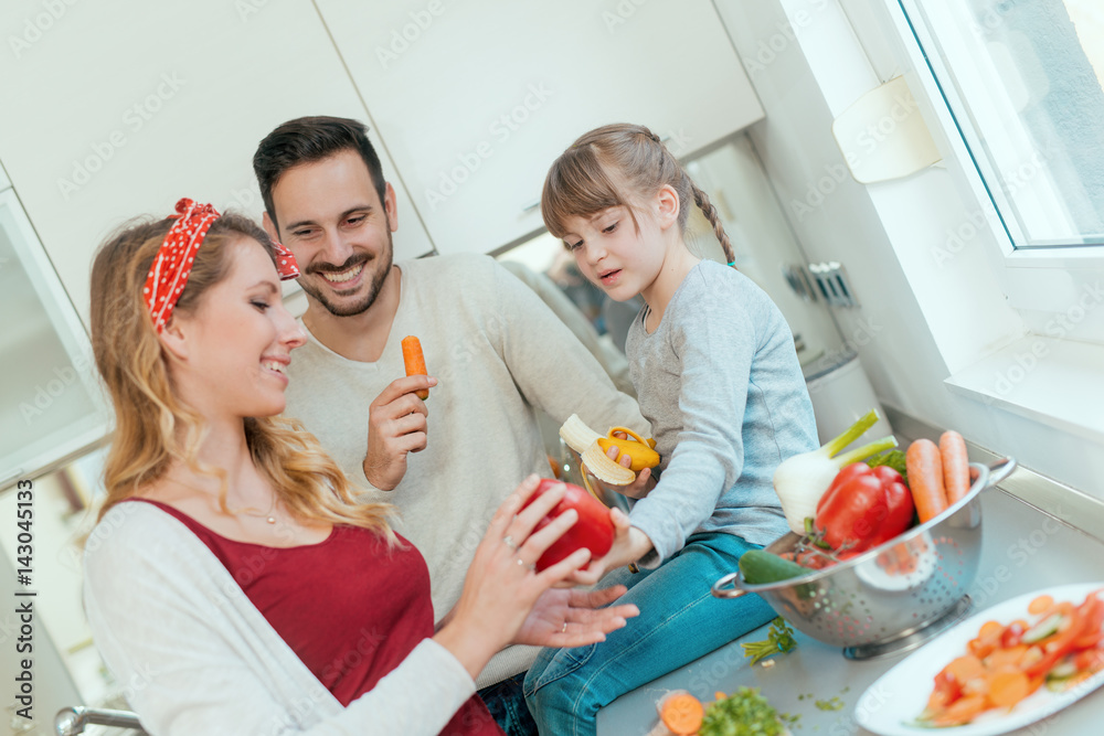 Young family preparing lunch from fresh veggies Young family preparing lunch from fresh veggies