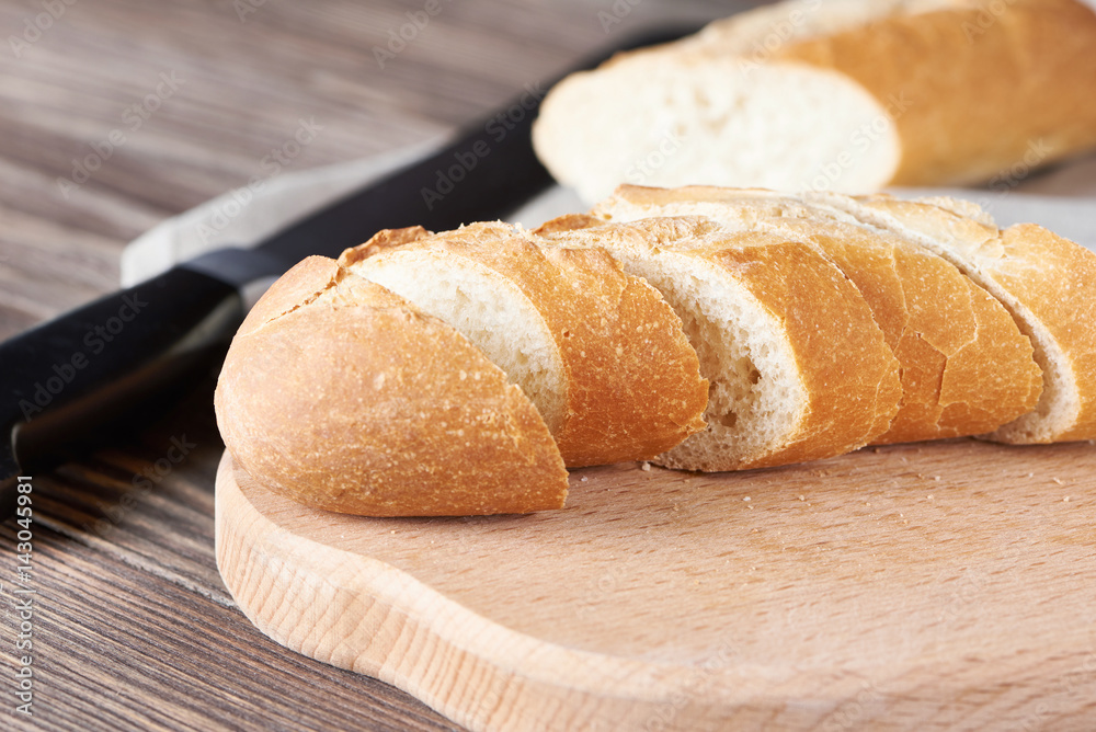 Sliced bread on the wooden plank