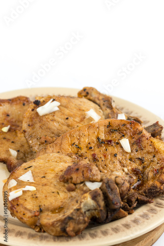 Fried pork chops served on the plate isolated over white background