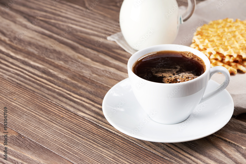 Cup of coffee, milk and waffles