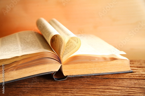 Old book put on the brown color hard wood represent book background concept related idea.