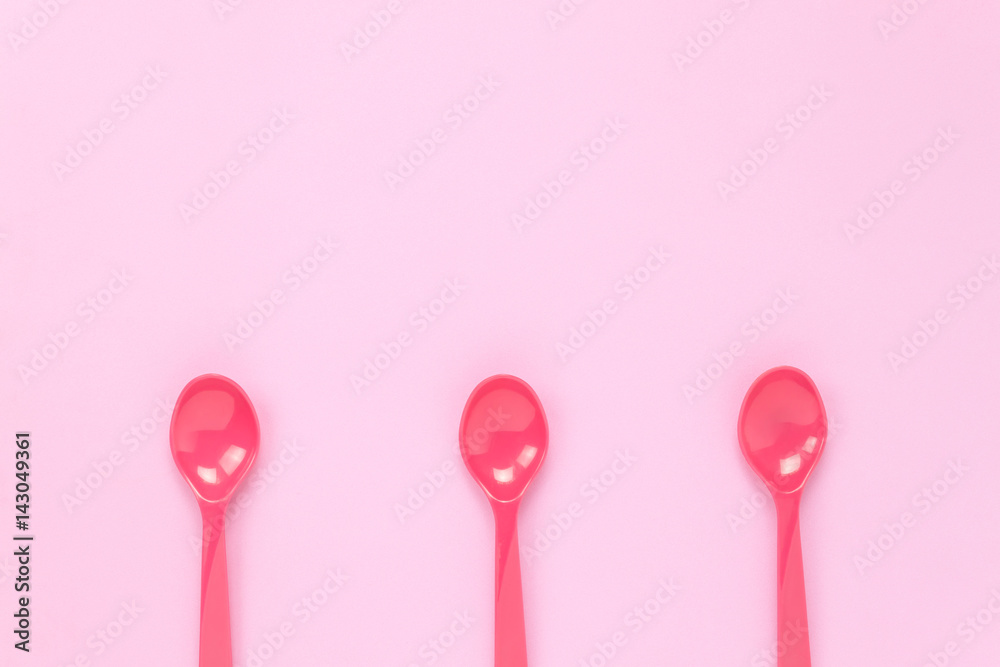 Top view colorful plastic spoon on pink table background with copy space. Top view colorful plastic spoon on pink table background with copy space.