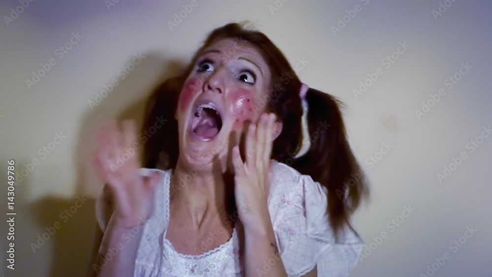 A scared woman dressed up like a little girl, running away from a danger we don't see. Funny comedic shot.
