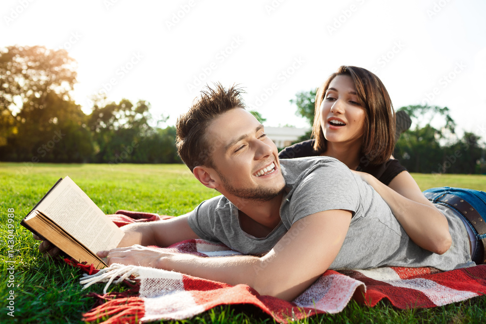 Young beautiful couple smiling, resting on picnic in park. Young beautiful couple smiling, resting on picnic in park.
