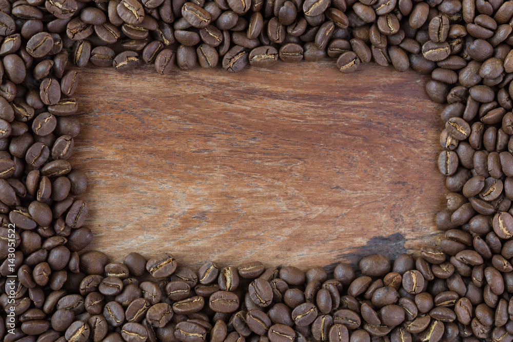 Roasted coffee beans on grunge wood background Roasted coffee beans on grunge wood background