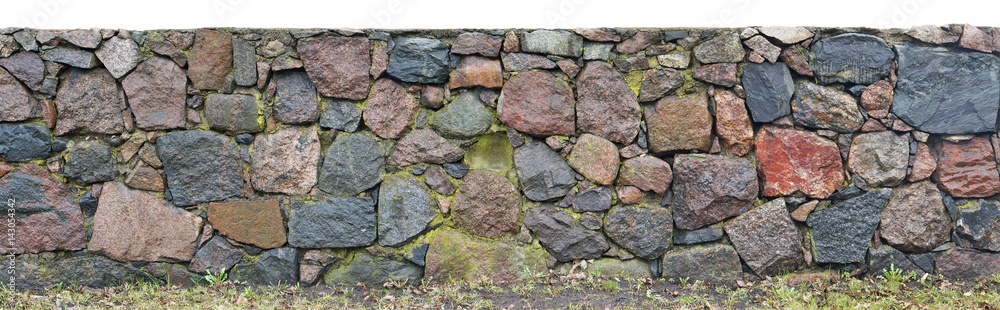 Long wall from big granite stones damp after rain