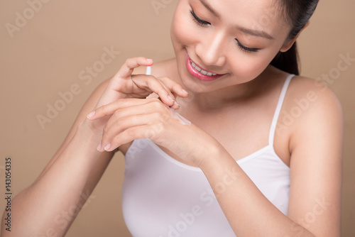 Clean fresh skincare concept. Young asian woman touching enjoying hand skin.