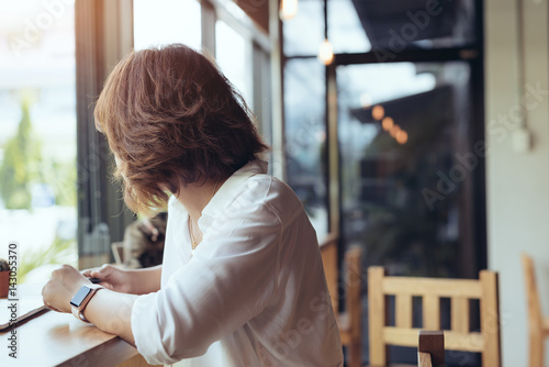 Asian girl waiting her boyfriend in a coffee shop