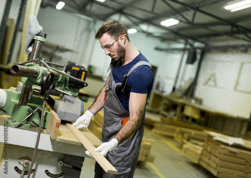 Handsome young man working in the furniture factory