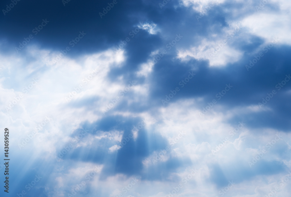 Light rays shine through the  clouds
