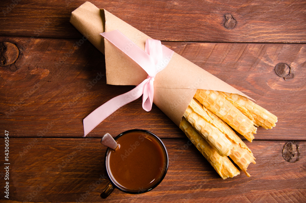 tubular wafer. waffles on wooden boards. hot chocolate. Kraft paper tubular wafer. waffles on wooden boards. hot chocolate. Kraft paper