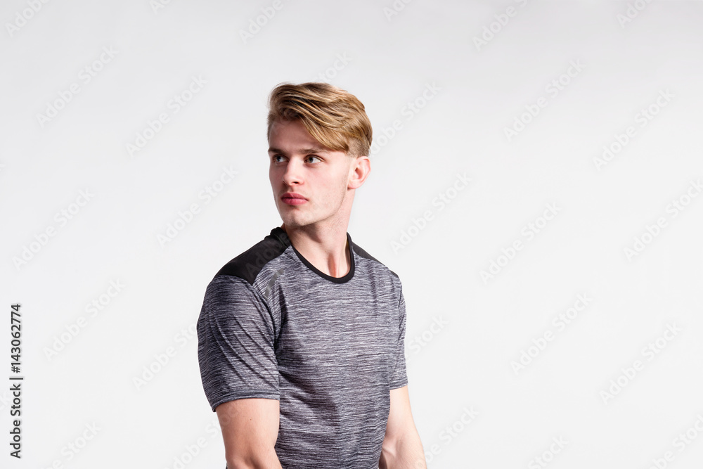 Young handsome hipster man in gray t-shirt, studio shot. Young handsome hipster man in gray t-shirt, studio shot.