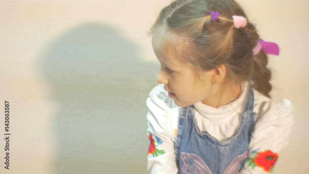 Amazing Six Year Blonde Girl is Working at a Pottery Wheel, Being Dressed in White Blose and Jeans Apron, She Entertains and Smiles, While Doing it Amazing Six Year Blonde Girl is Working at a Pottery Wheel, Being Dressed in White Blose and Jeans Apron, She Entertains and Smiles, While Doing it