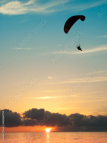 paragliding on the see at the sunset