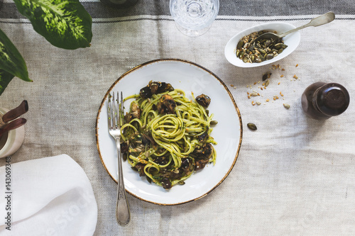 Horizontal View of Mushroom and Pesto Linguine Supper on Table