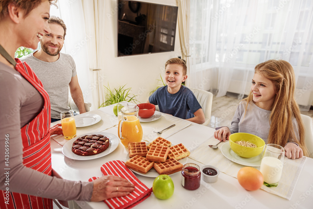Friendly family eating breakfast at home Friendly family eating breakfast at home