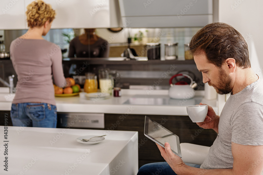 Married couple entertaining in kitchen Married couple entertaining in kitchen