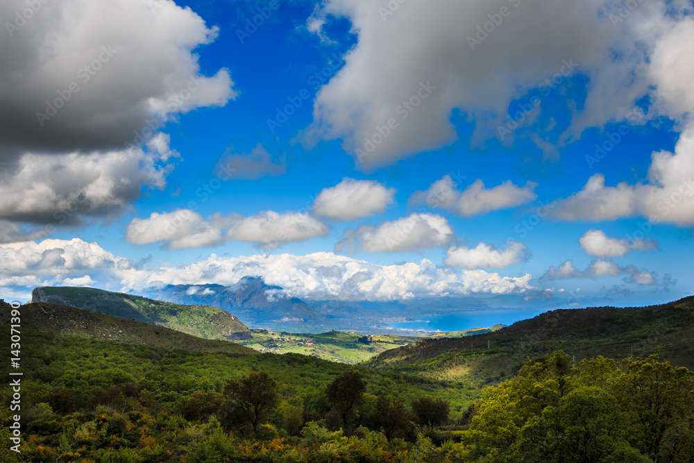 Sicilian landscape of blue sky, clouds and green Mountains and hills Sicilian landscape of blue sky, clouds and green Mountains and hills