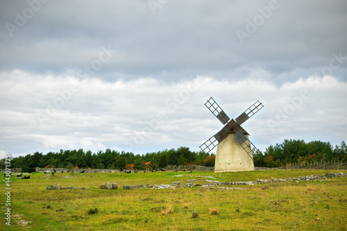 Landscape with stormy sky and windmill in Gotland, Sweden