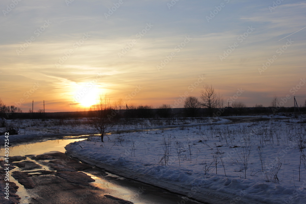 winter road is in a rural location sunset