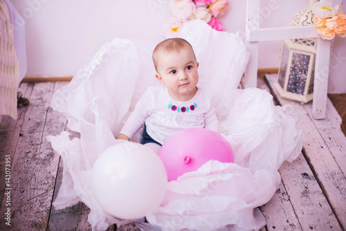 infant baby sitting in a large flower photo