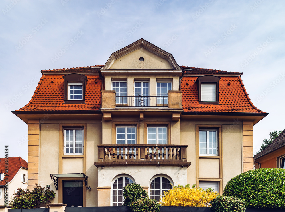 Classic french house in residential district of Strasbourg, blossom spring time, flowering and gardening.