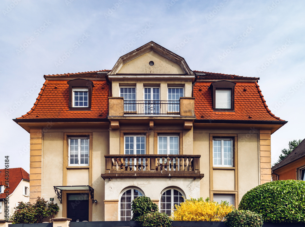 Fototapeta premium Classic french house in residential district of Strasbourg, blossom spring time, flowering and gardening.
