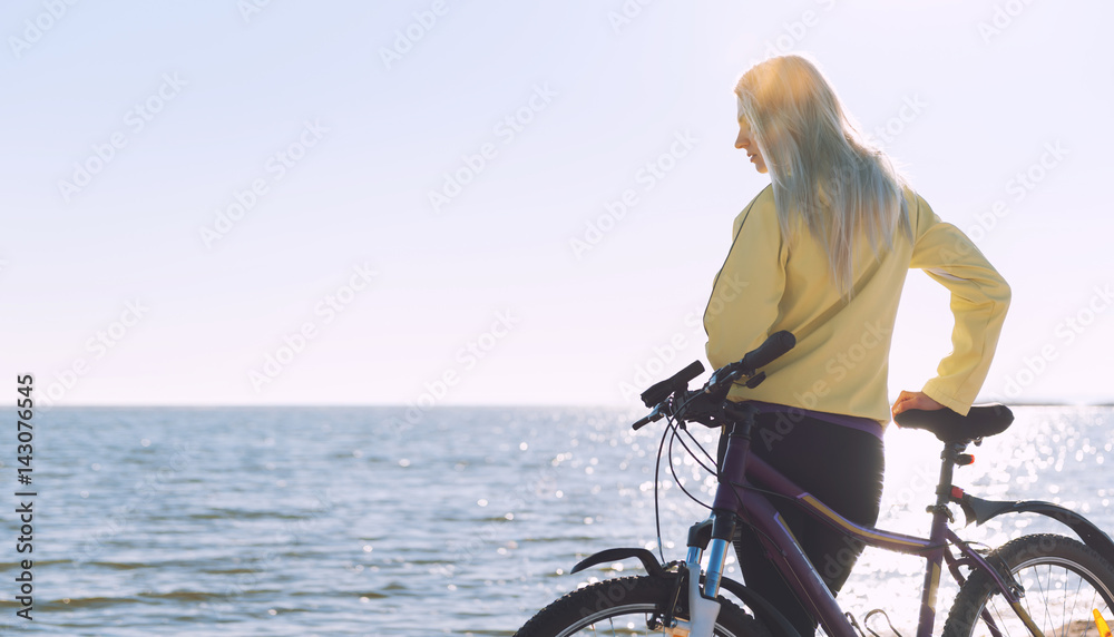 A girl on a bicycle by the sea A girl on a bicycle by the sea