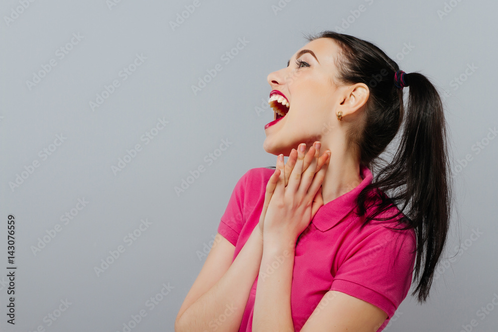 Woman surprise holds cheeks by hand .Beautiful girl . Expressive facial expressions Woman surprise holds cheeks by hand .Beautiful girl . Expressive facial expressions