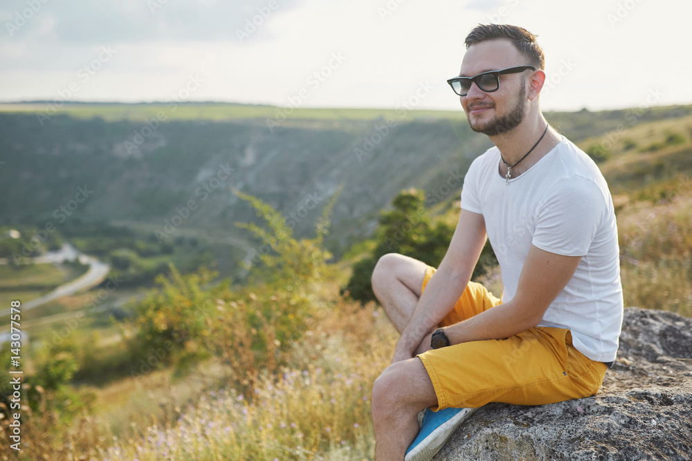 Young man smiling and enjoying sunny summer day Young man smiling and enjoying sunny summer day
