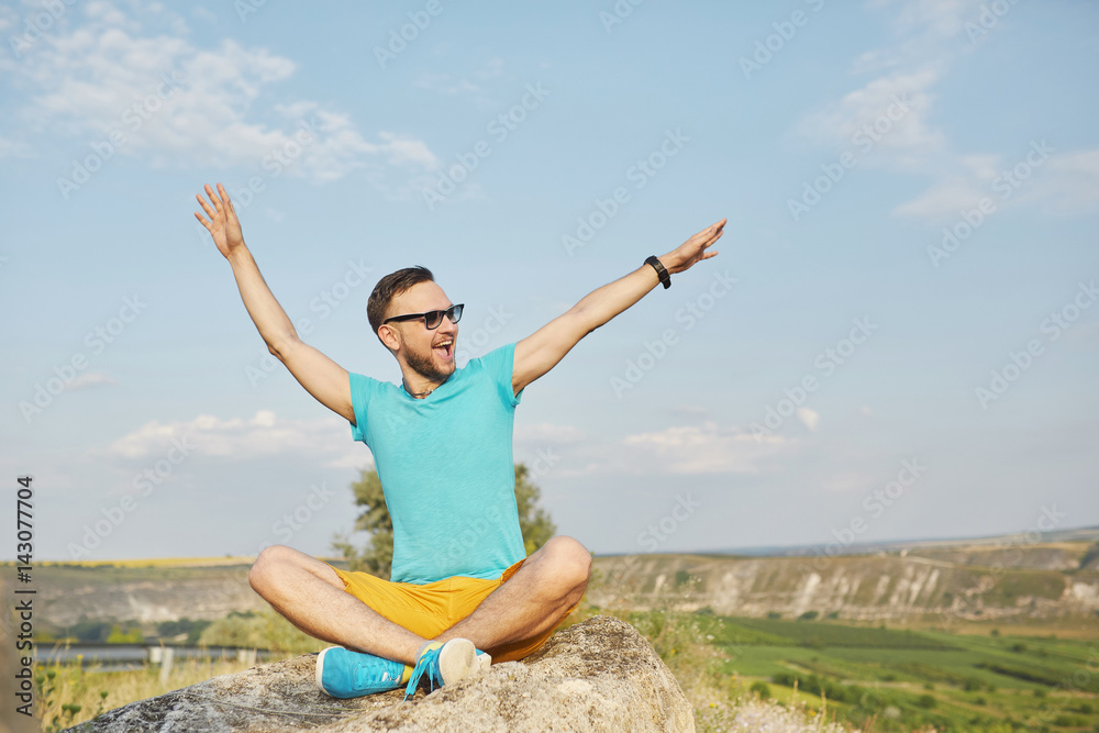 Young man smiling and enjoying sunny summer day Young man smiling and enjoying sunny summer day