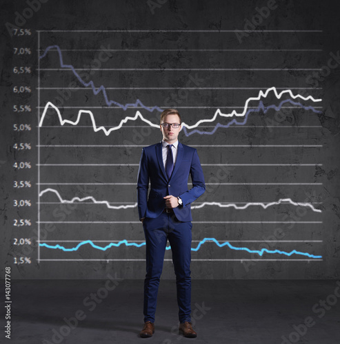 Businessman standing on a diagram background. Business, finance, investment concept.