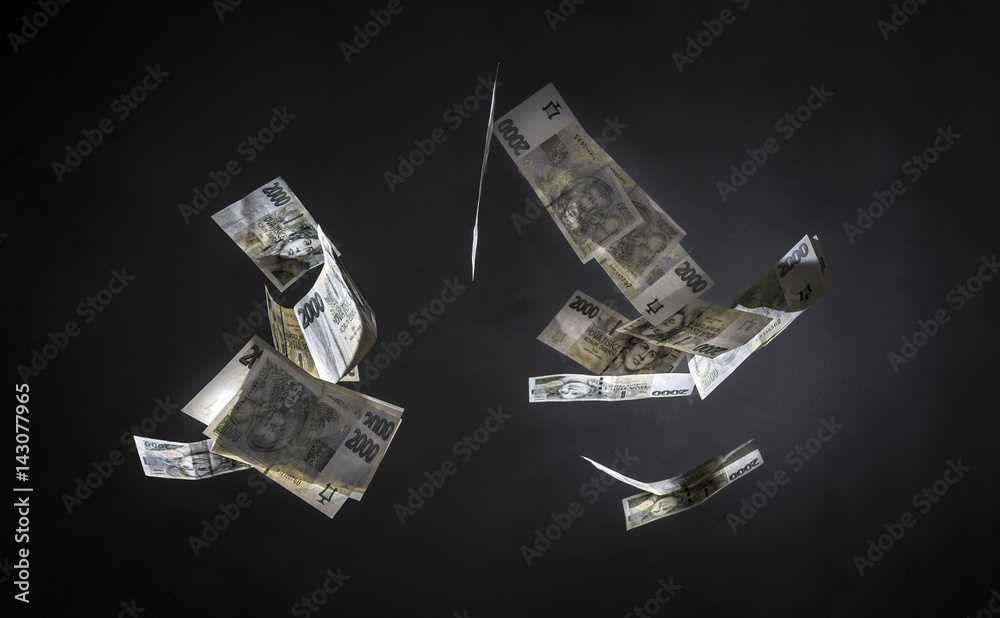 Czech money (2000 crowns banknotes) freeze in motion on black background