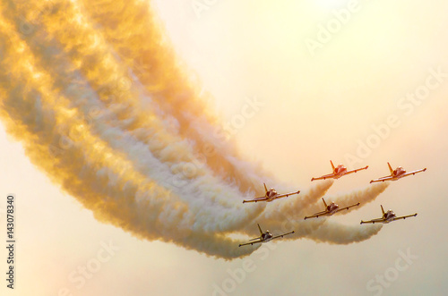 Aircraft fighter jets smoke the background of sky and sun