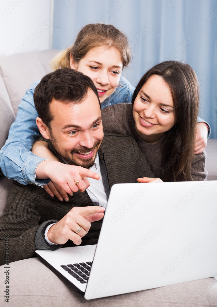 Family booking hotel online on laptop