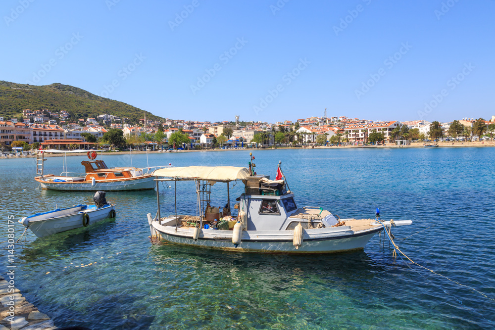 Some boats with Datca beach and city background
