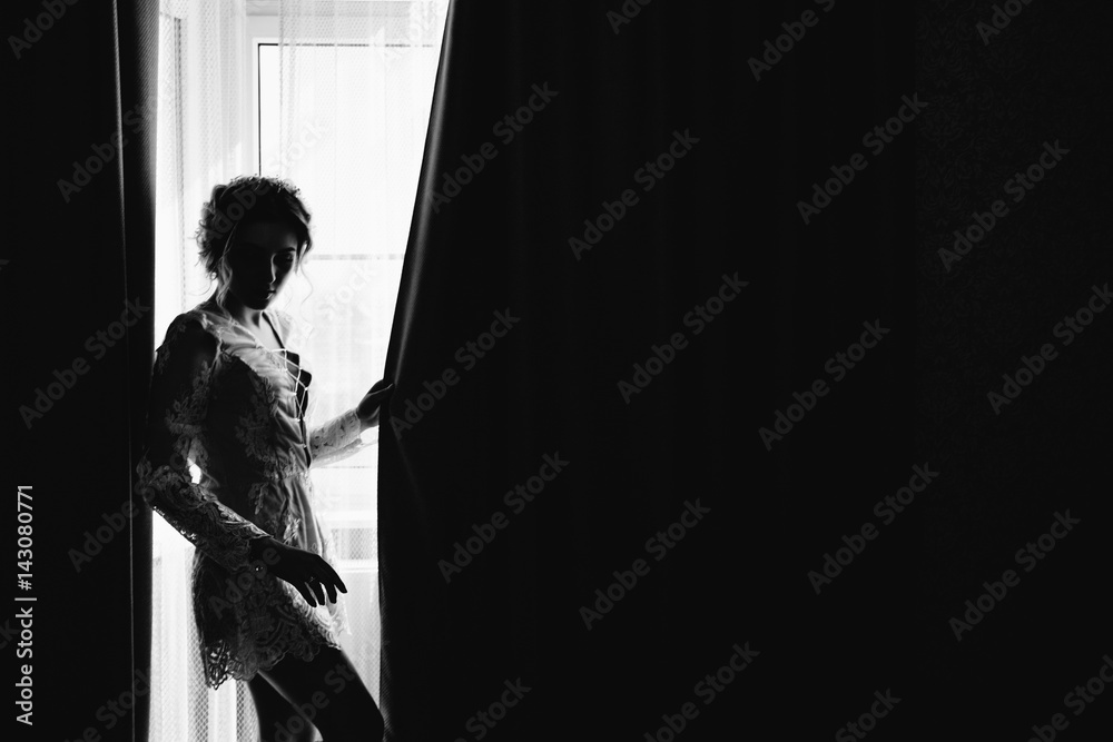 pretty girl or cute woman with long brunette hair in sexy fashionable white bodysuit and shoes on window sill on natural background, copy space pretty girl or cute woman with long brunette hair in sexy fashionable white bodysuit and shoes on window sill on natural background, copy space