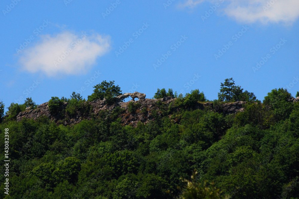 Natural rock window in mountains in Zorunovac, Serbia. Window on cliff with a blue dynamic sky
